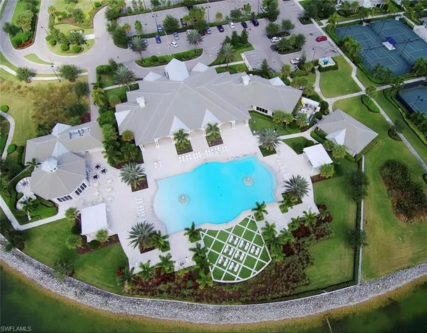 an aerial view of a house with a swimming pool and garden