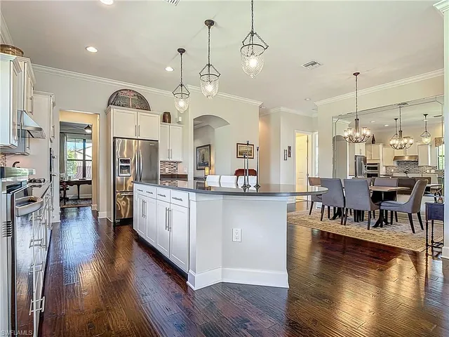 a large kitchen with a lot of counter space and a wooden floor