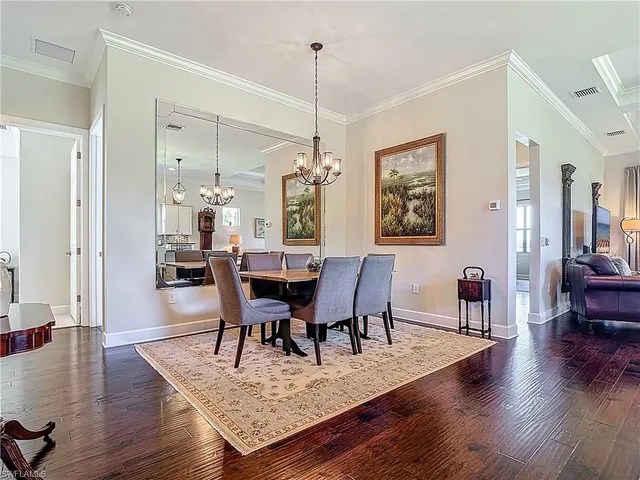 a view of a dining room with furniture wooden floor and a chandelier