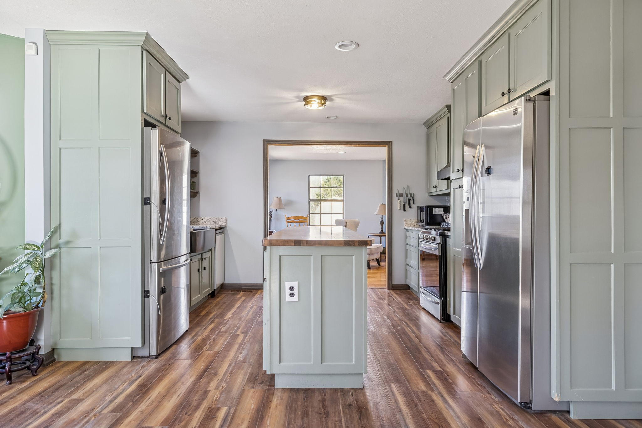 485 Lower Roans Creek Road Linden, TN 37096 - Photo 16 of 43 a kitchen with kitchen island wooden floor center island and stainless steel appliances