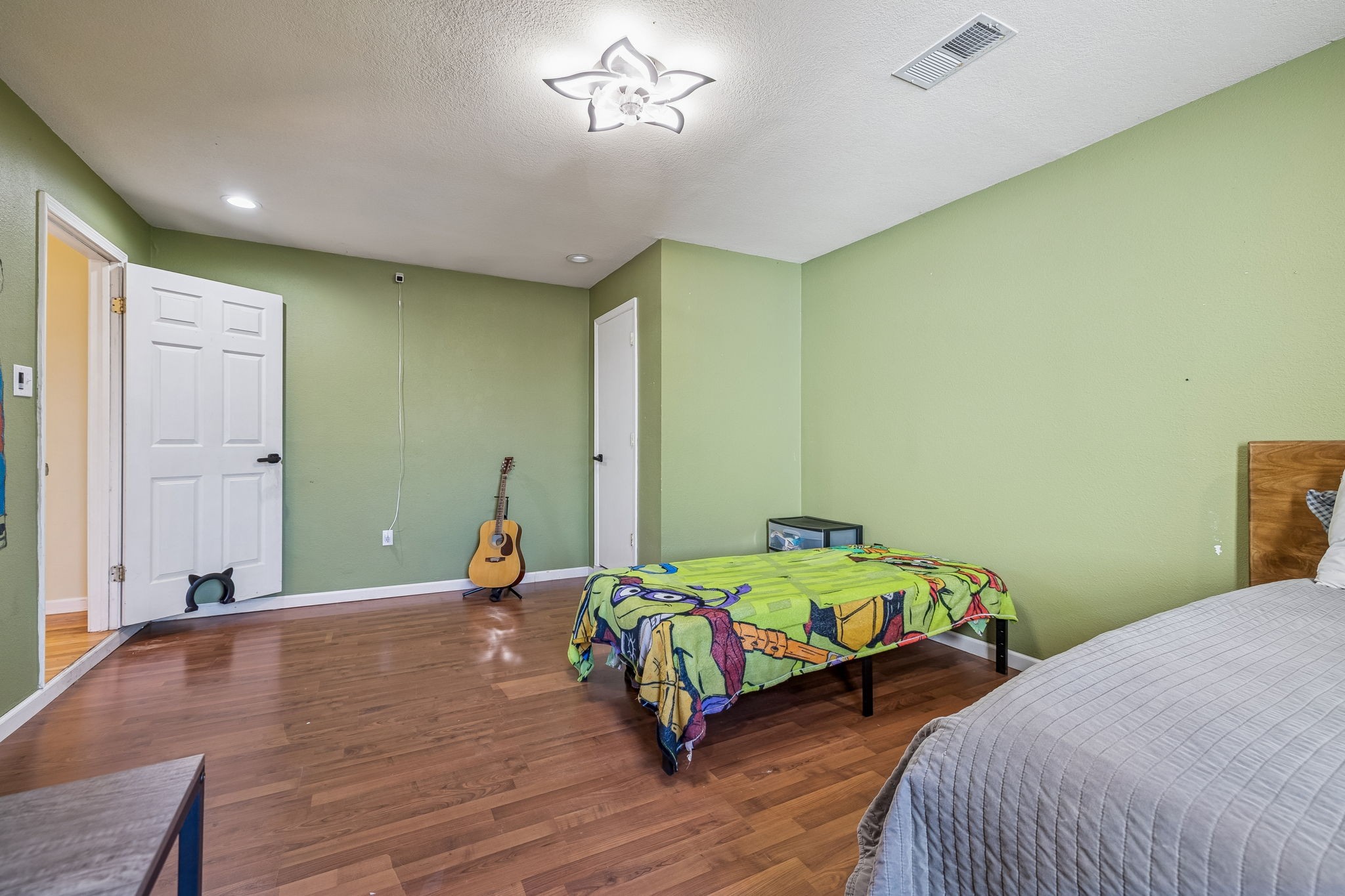 485 Lower Roans Creek Road Linden, TN 37096 - Photo 31 of 43 a bedroom with a bed and wooden floor