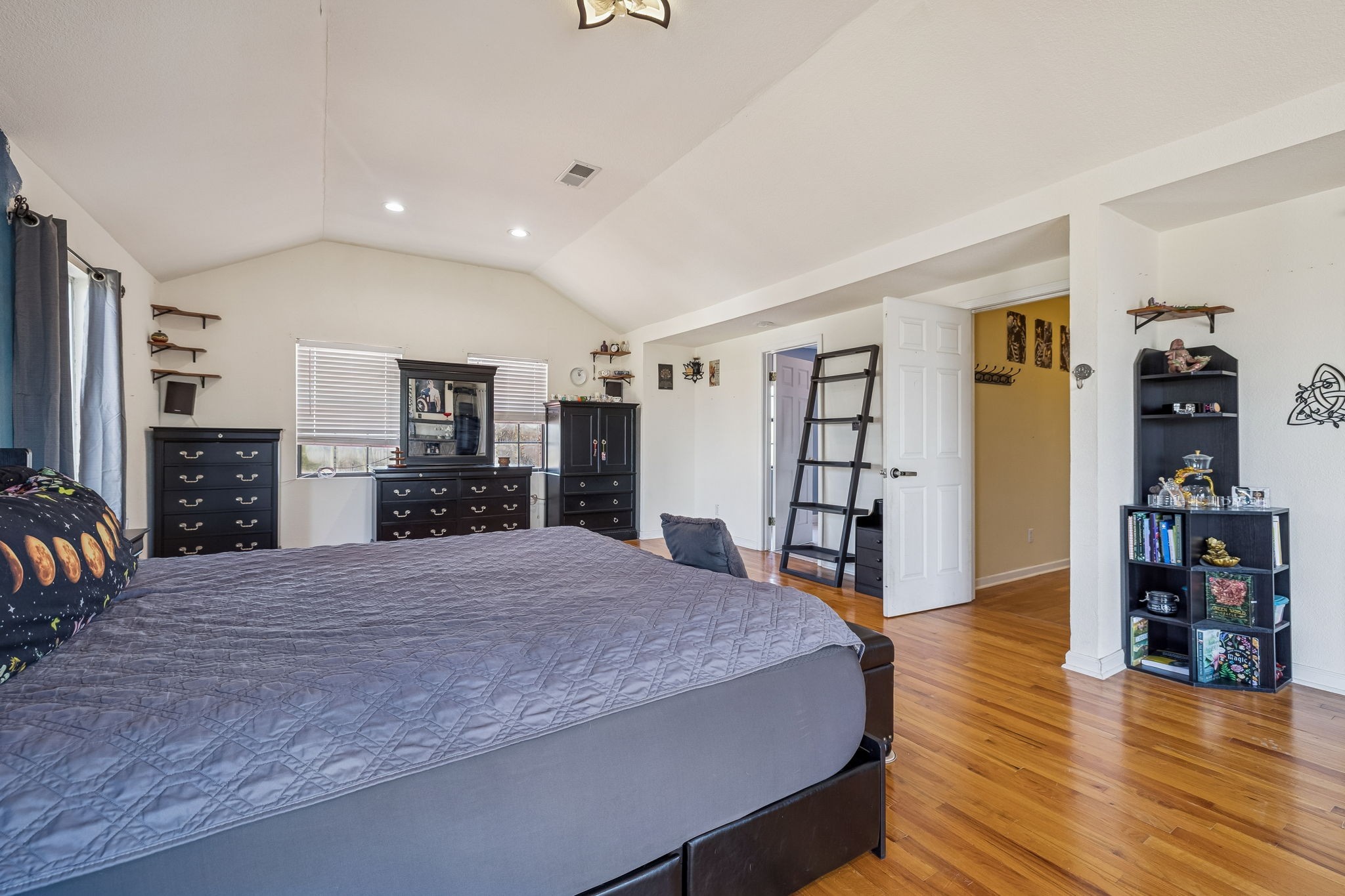 485 Lower Roans Creek Road Linden, TN 37096 - Photo 5 of 43 a spacious bedroom with a large bed and a wooden floor