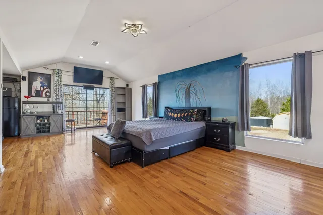 a bedroom with a bed and two lamp on desk