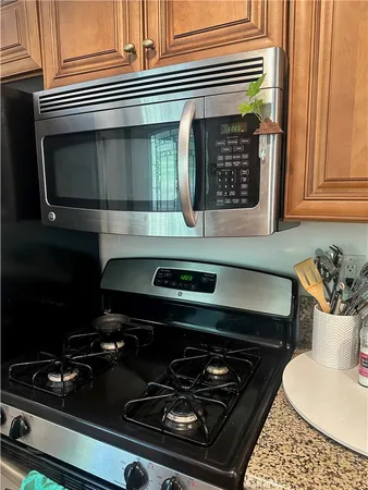 a stove top oven sitting inside of a kitchen