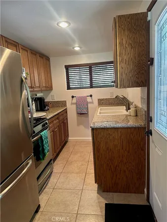 a kitchen with a sink stove and refrigerator