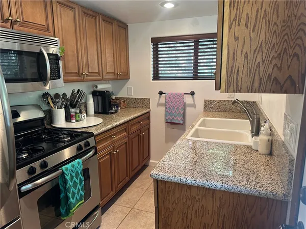 a kitchen with stainless steel appliances granite countertop a stove and a sink