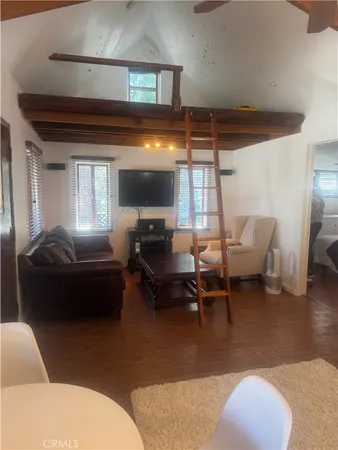 a living room with furniture a window and a table