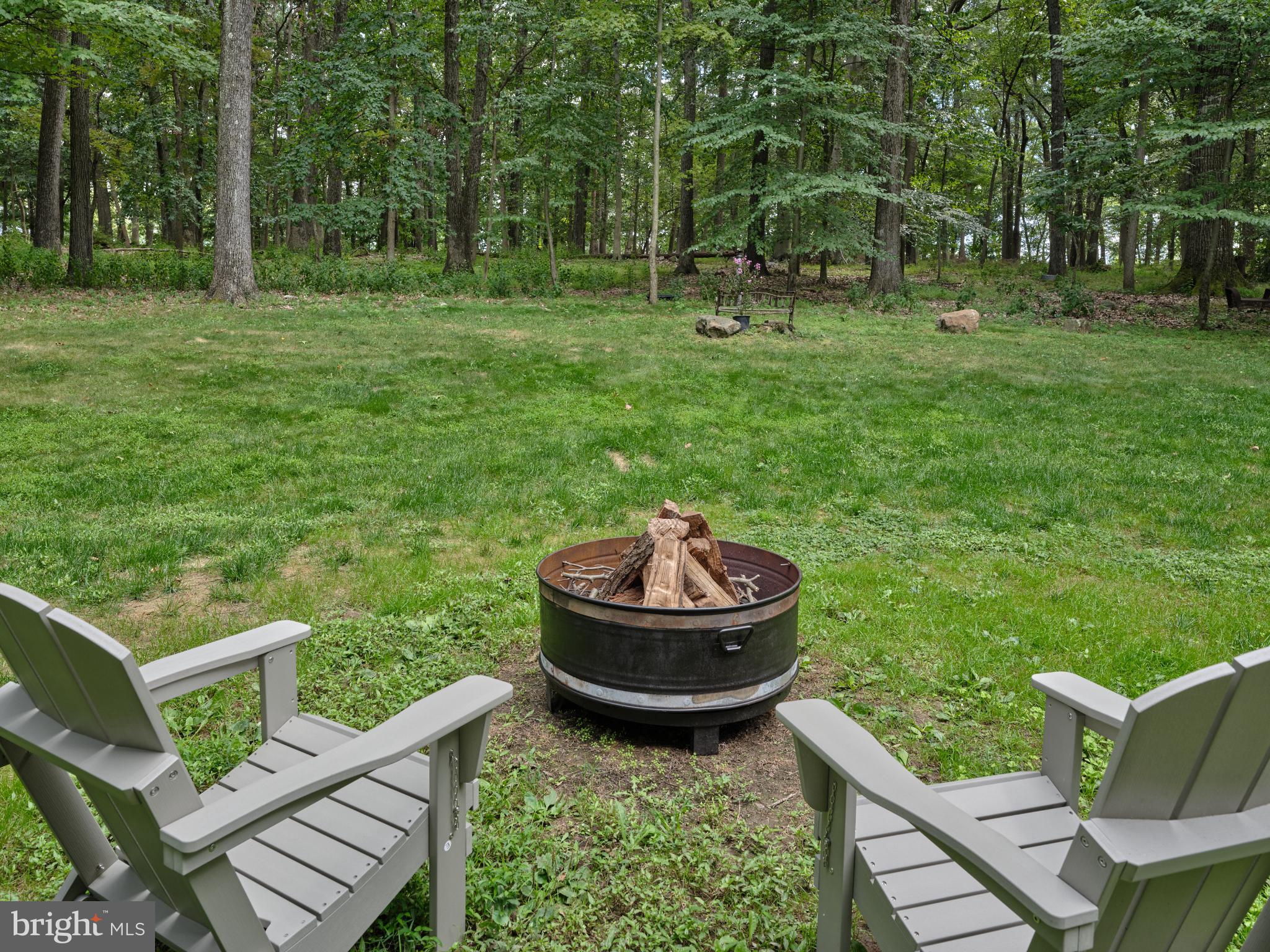 7000 Ely Road New Hope, PA 18938 - Photo 36 of 44 a view of a backyard with table and chairs and a grill