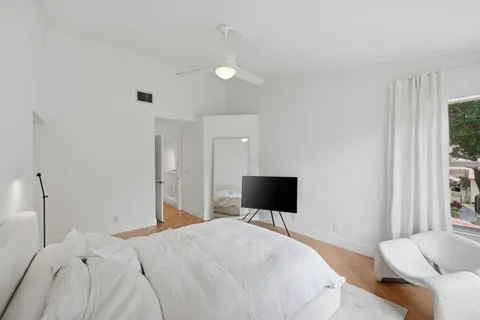 a patio with a table and chairs and potted plants