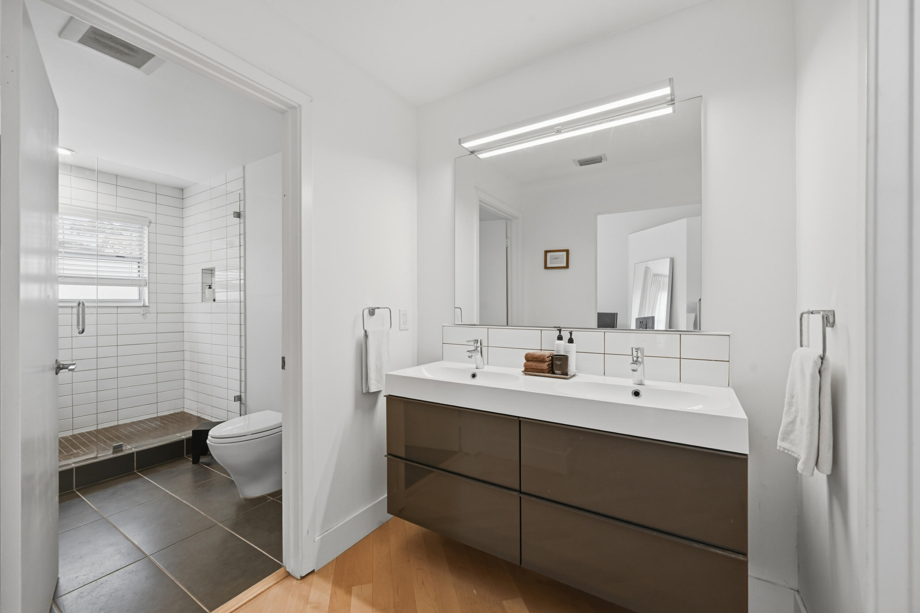 5205 Majorca Club Drive Boca Raton, FL 33486 - Photo 17 of 29 a bathroom with a double vanity sink toilet and shower