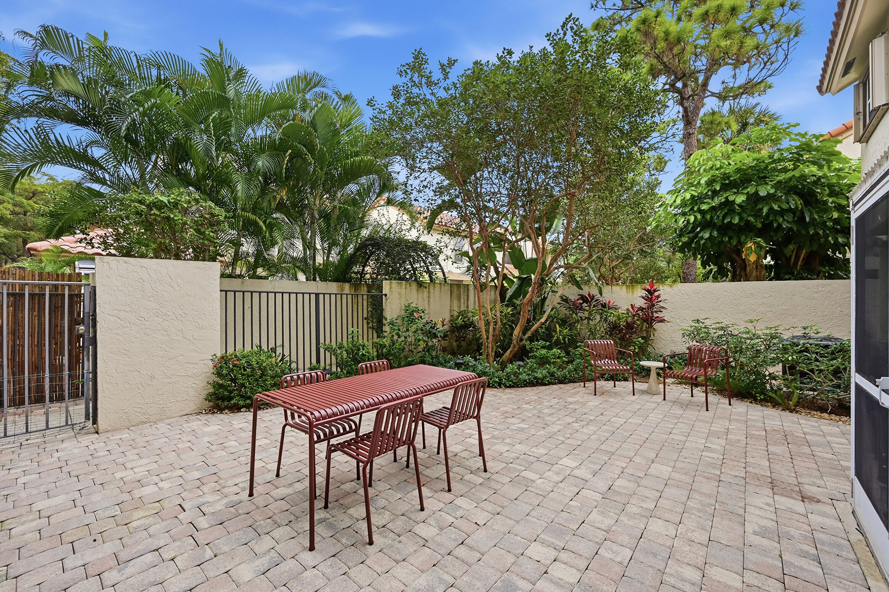 5205 Majorca Club Drive Boca Raton, FL 33486 - Photo 24 of 29 a patio with a table and chairs and potted plants
