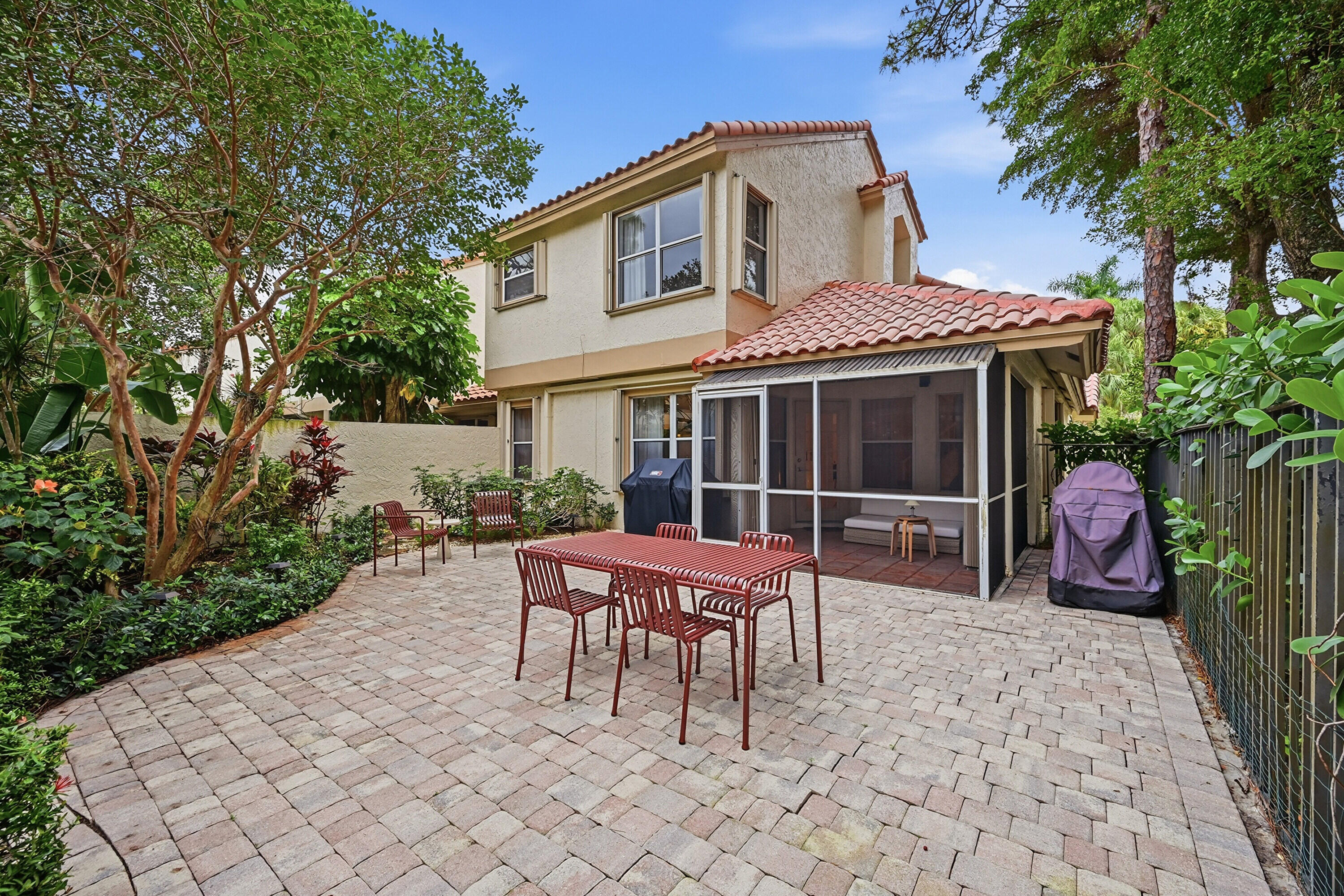 5205 Majorca Club Drive Boca Raton, FL 33486 - Photo 25 of 29 a wooden bench sitting in front of a house