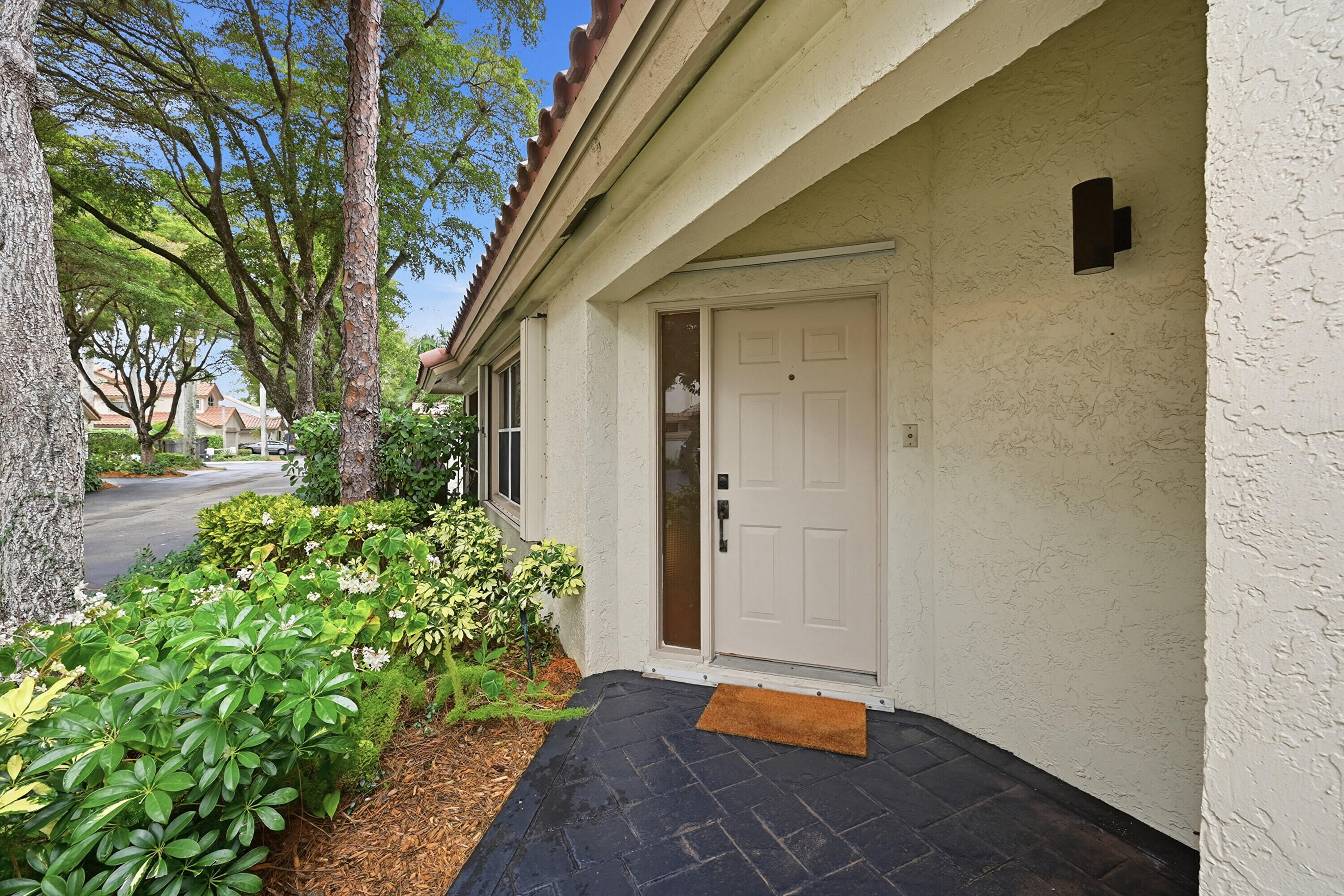 5205 Majorca Club Drive Boca Raton, FL 33486 - Photo 4 of 29 a backyard of a house with an outdoor space and shower