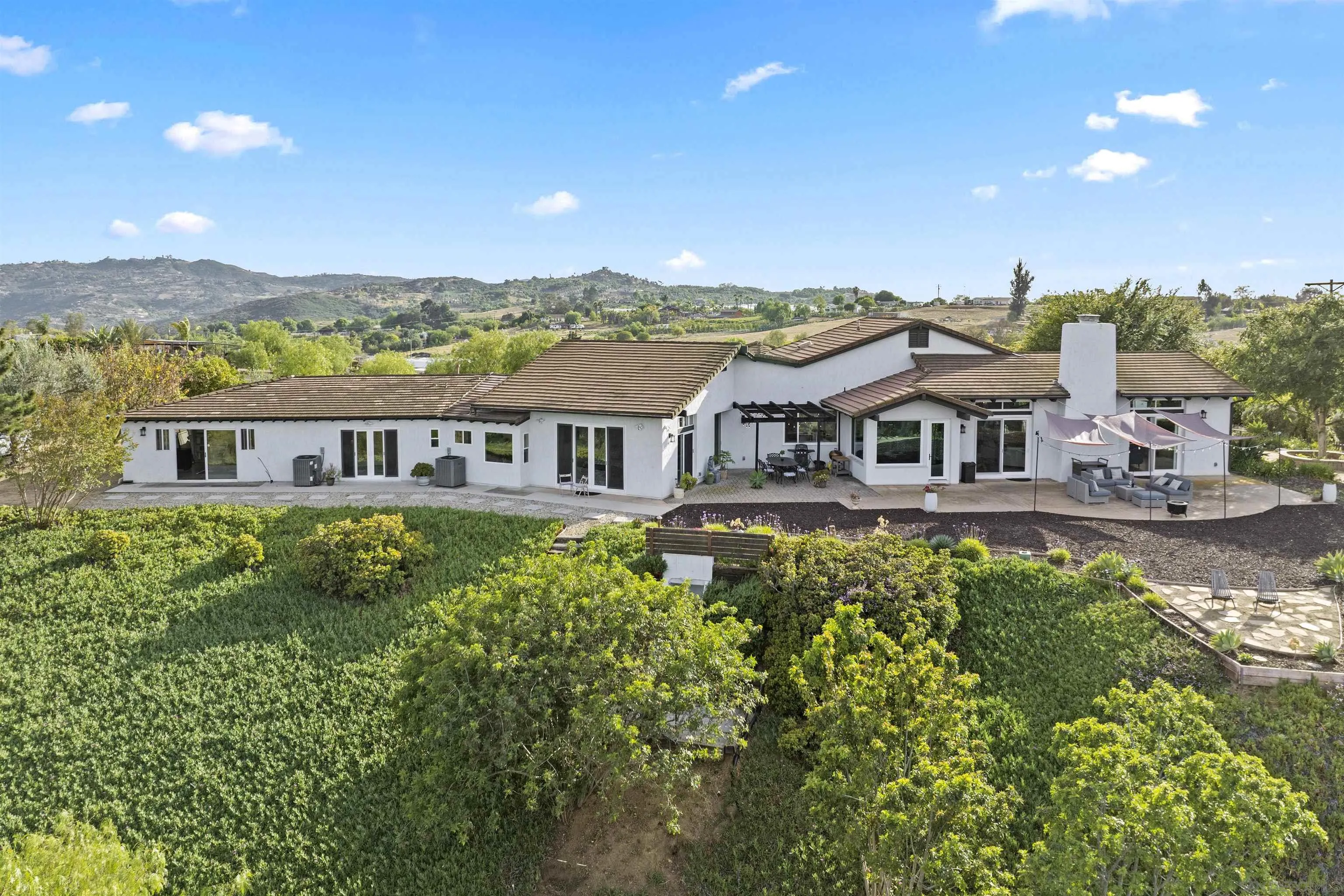 30659 Diaz Road Valley Center, CA 92082 - Photo 15 of 44 a aerial view of a house with a big yard and large trees