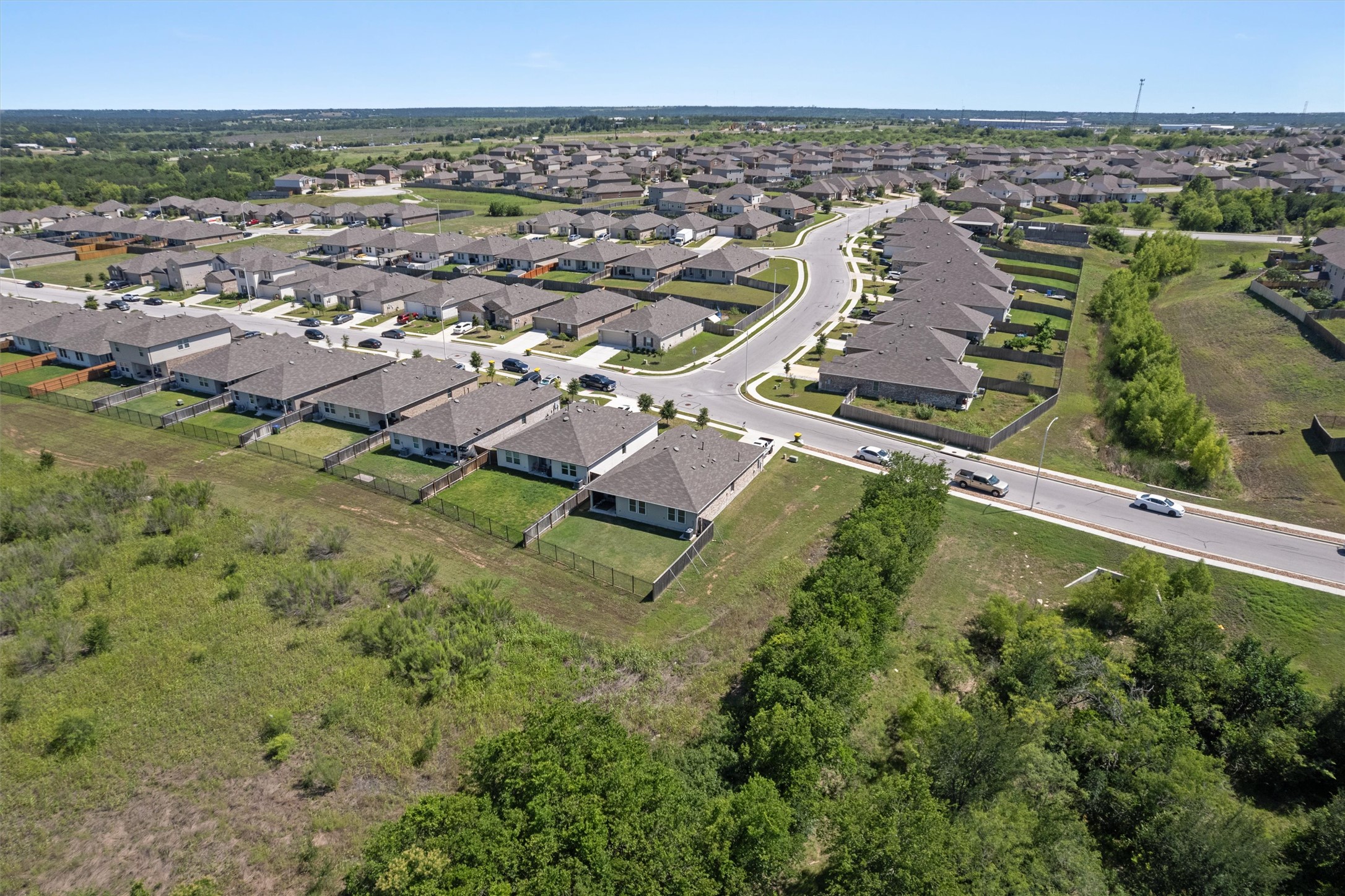19912 Abigail Fillmore Road Manor, TX 78653 - Photo 3 of 31 An aerial perspective reveals a vibrant community with houses nestled alongside green spaces.