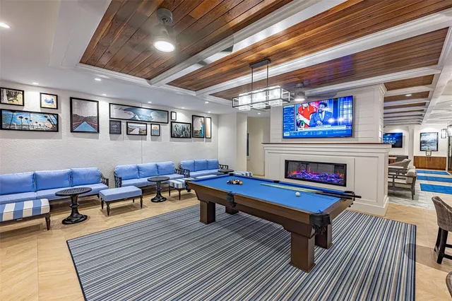 a living room with furniture large window and flat screen tv