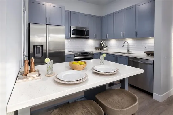a kitchen with a table chairs stove and microwave