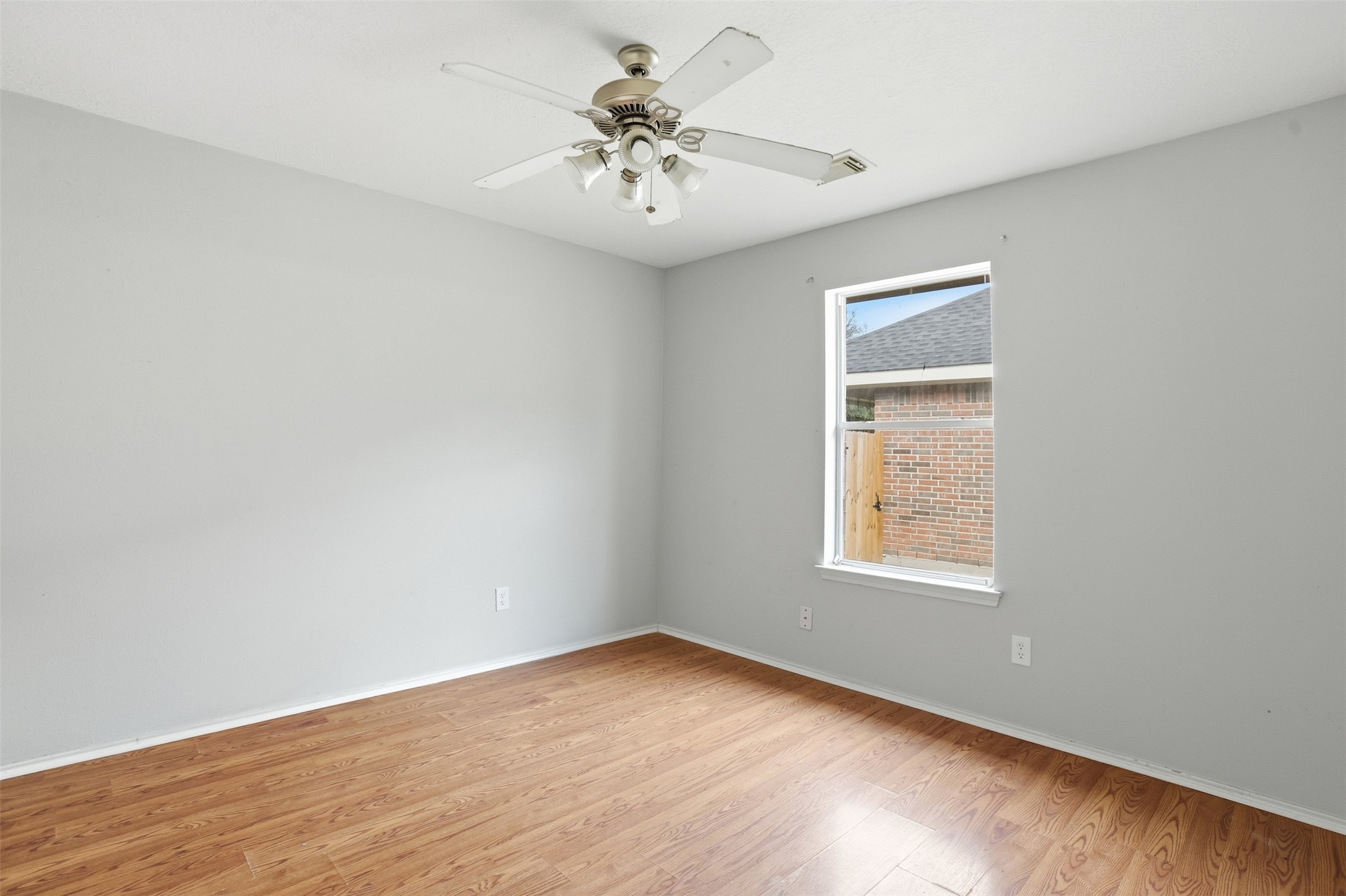 9815 Wedgeford Court Houston, TX 77044 - Photo 14 of 24 an empty room with windows and fan