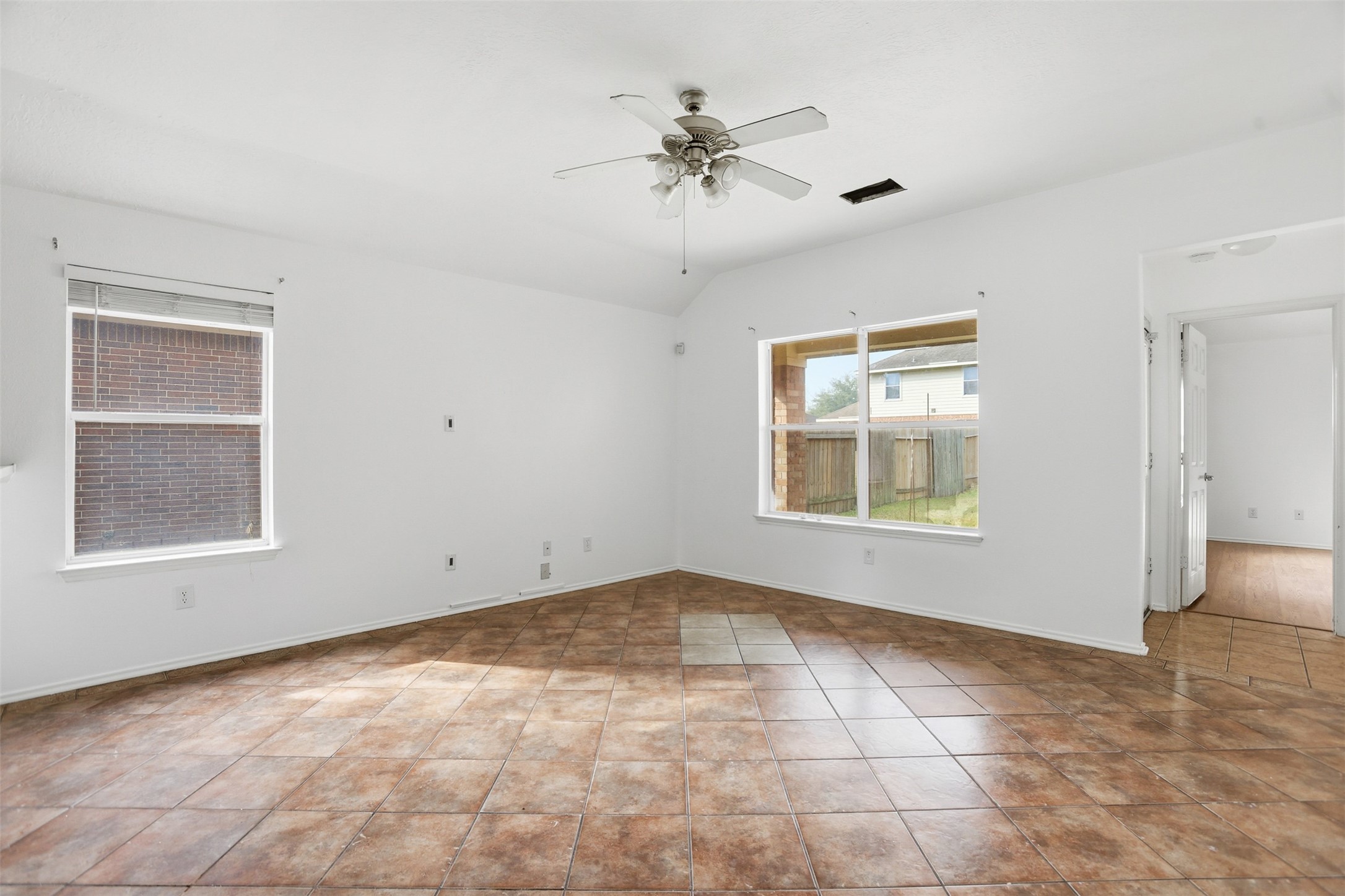 9815 Wedgeford Court Houston, TX 77044 - Photo 18 of 24 an empty room with a ceiling fan and a window