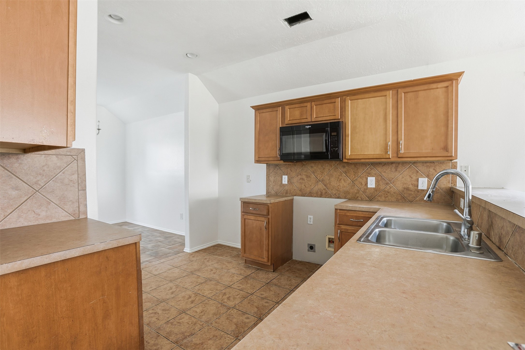 9815 Wedgeford Court Houston, TX 77044 - Photo 20 of 24 a kitchen with a sink a stove and cabinets