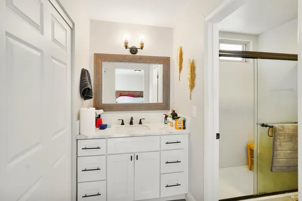 a bathroom with a sink vanity and a mirror