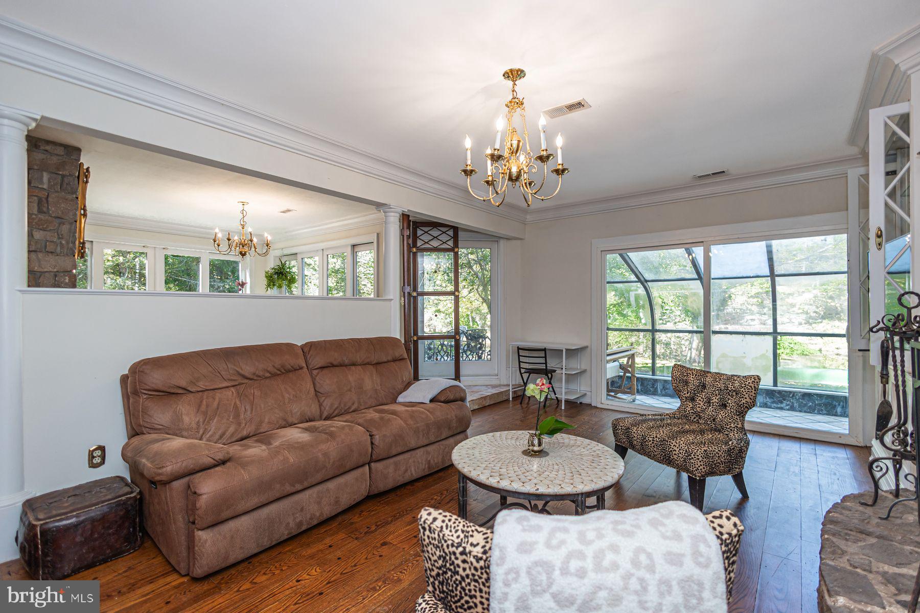 132 East Dark Hollow Road, Unit MAIN Pipersville, PA 18947 - Photo 12 of 29 a living room with furniture chandelier and a table