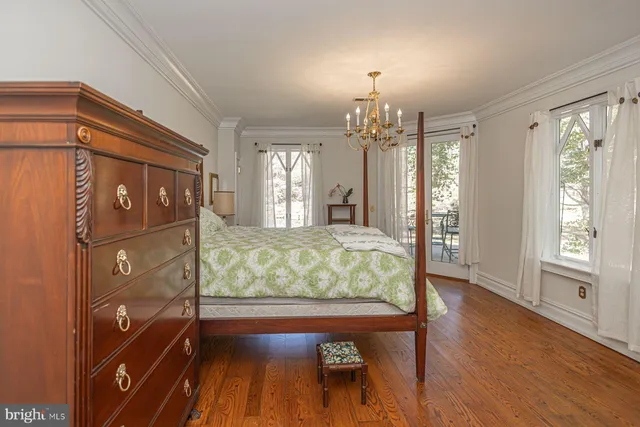 a bed room with a bed mirror and a window