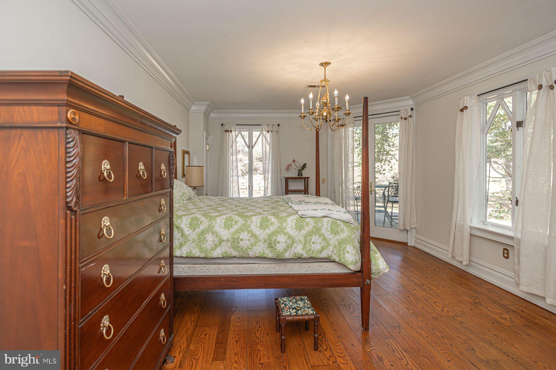 132 East Dark Hollow Road, Unit MAIN Pipersville, PA 18947 - Photo 13 of 29 a bed room with a bed mirror and a window