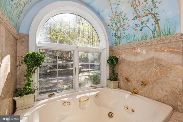 a bathroom with a tub and a window