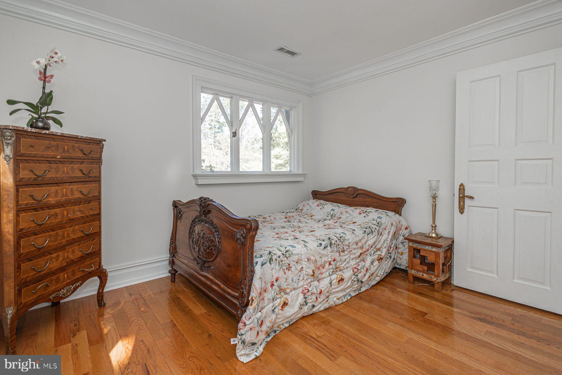 132 East Dark Hollow Road, Unit MAIN Pipersville, PA 18947 - Photo 18 of 29 a bedroom with a bed and a dresser