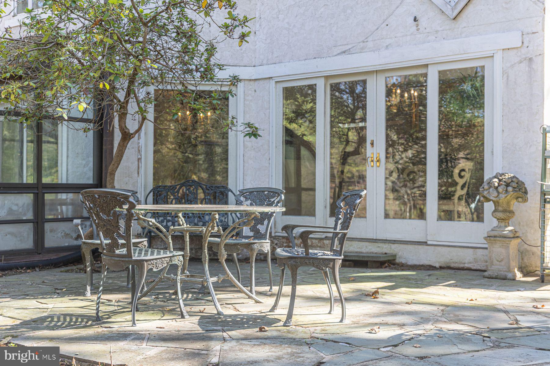 132 East Dark Hollow Road, Unit MAIN Pipersville, PA 18947 - Photo 24 of 29 a view of a patio with a table and chairs