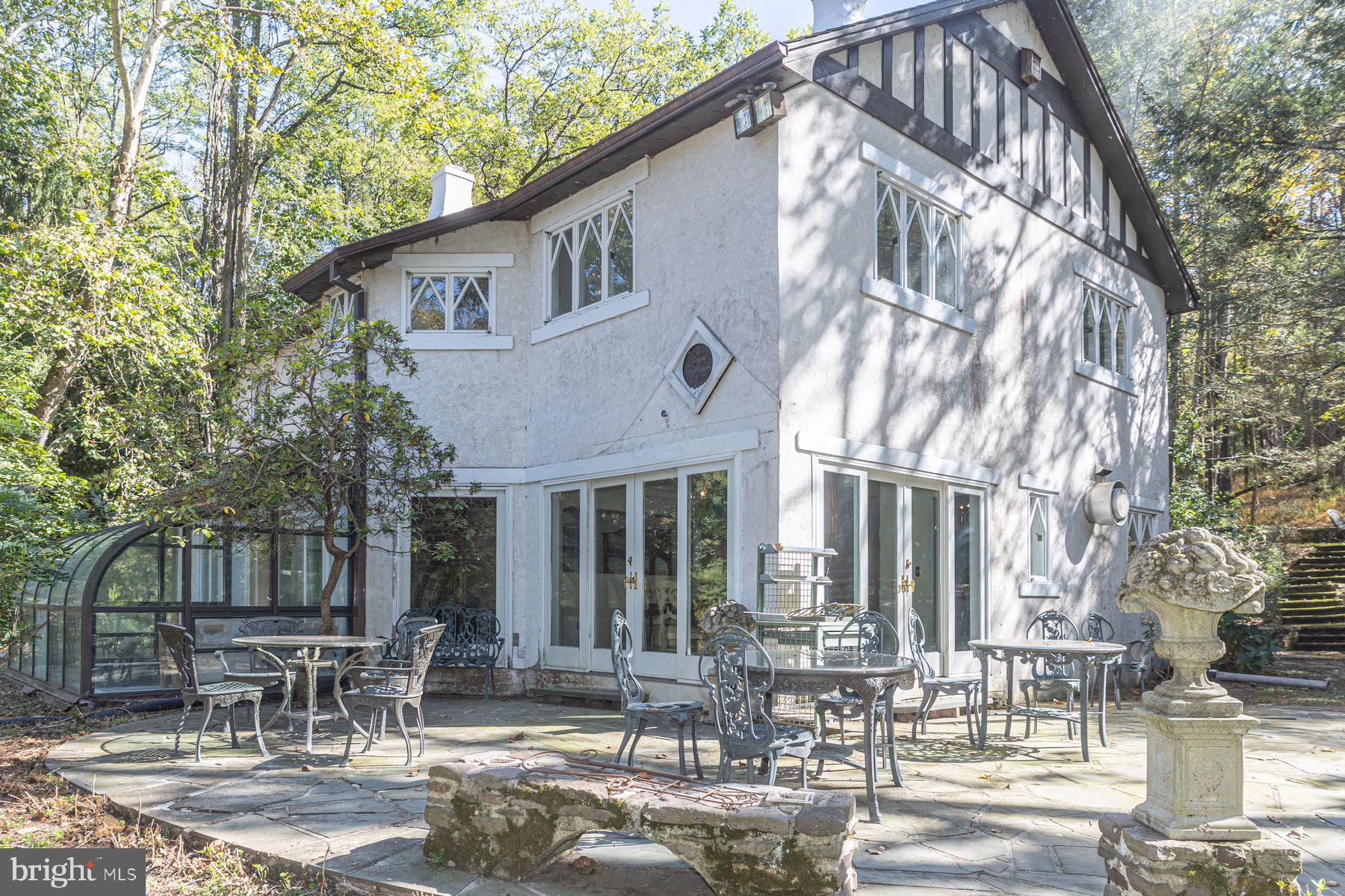 132 East Dark Hollow Road, Unit MAIN Pipersville, PA 18947 - Photo 26 of 29 a patio with table and chairs and potted plants