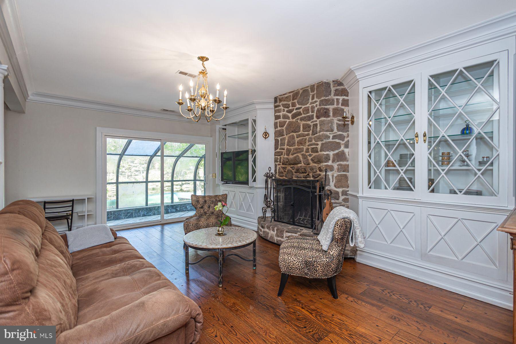 132 East Dark Hollow Road, Unit MAIN Pipersville, PA 18947 - Photo 9 of 29 a living room with furniture and a fireplace