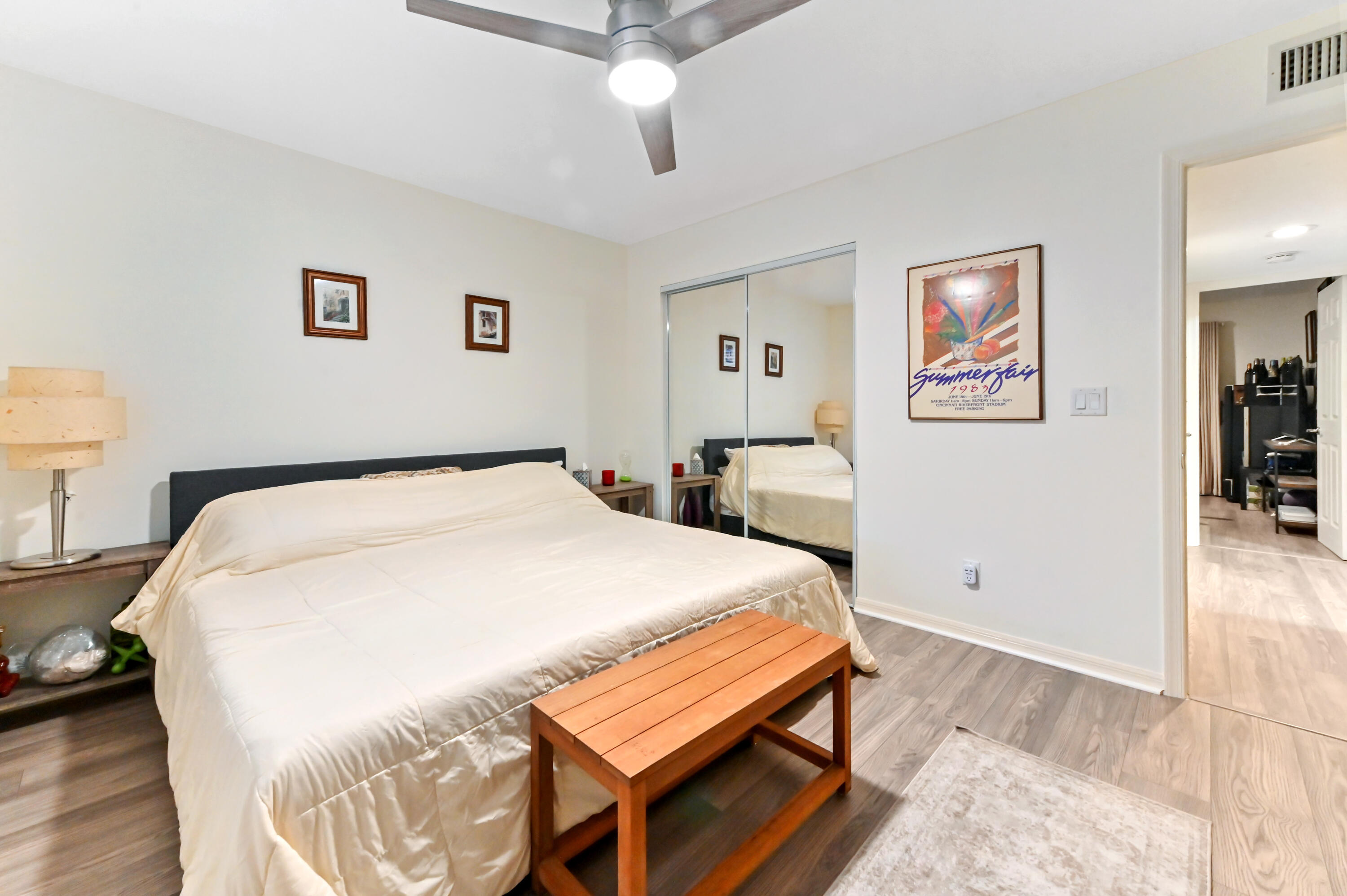 1230 Southeast Parkview Place, Unit D2 Stuart, FL 34994 - Photo 15 of 34 a bed room with a bed and a painting on the wall