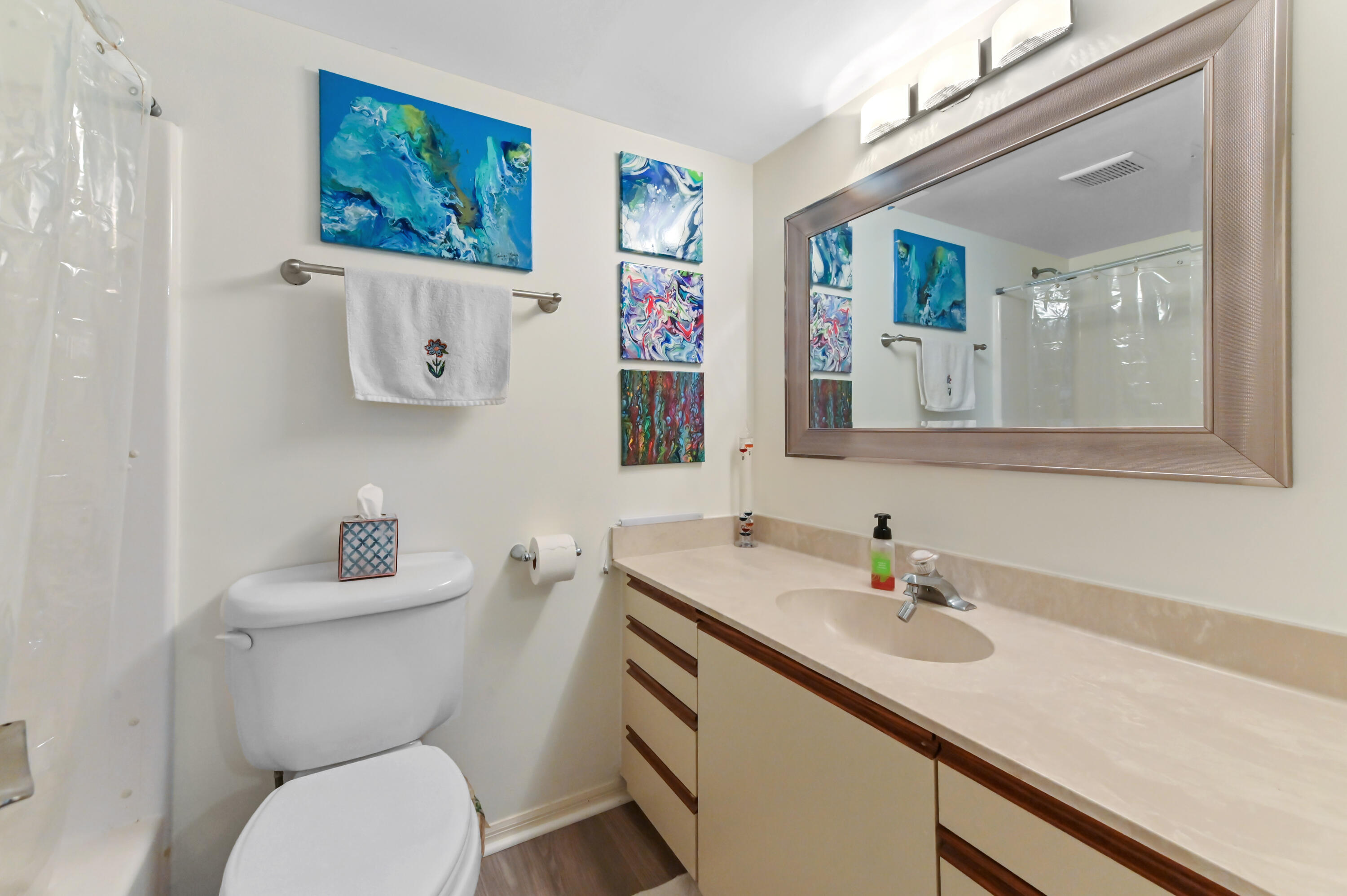 1230 Southeast Parkview Place, Unit D2 Stuart, FL 34994 - Photo 19 of 34 a bathroom with a sink mirror and toilet