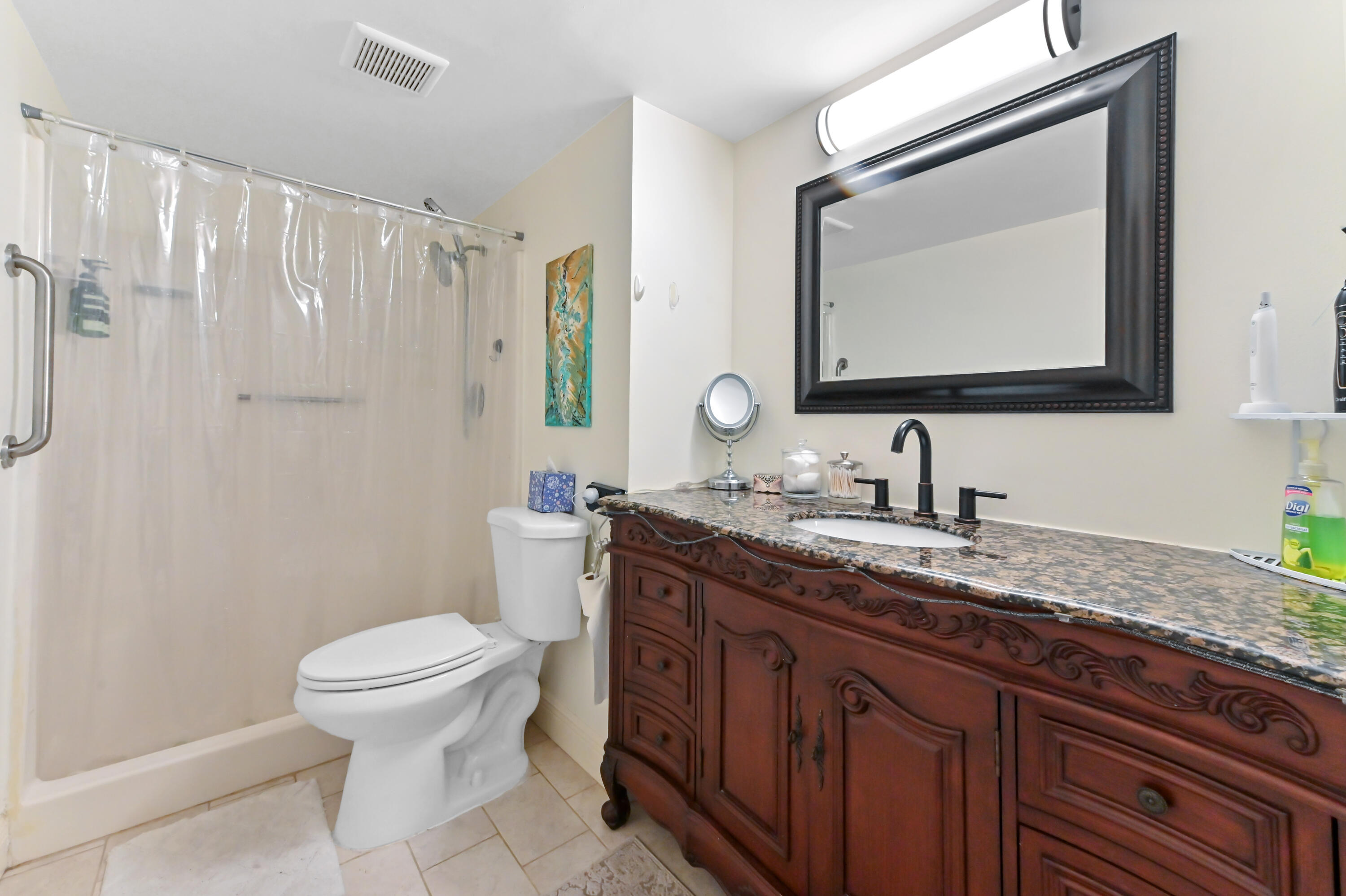 1230 Southeast Parkview Place, Unit D2 Stuart, FL 34994 - Photo 25 of 34 a bathroom with a granite countertop sink toilet and mirror