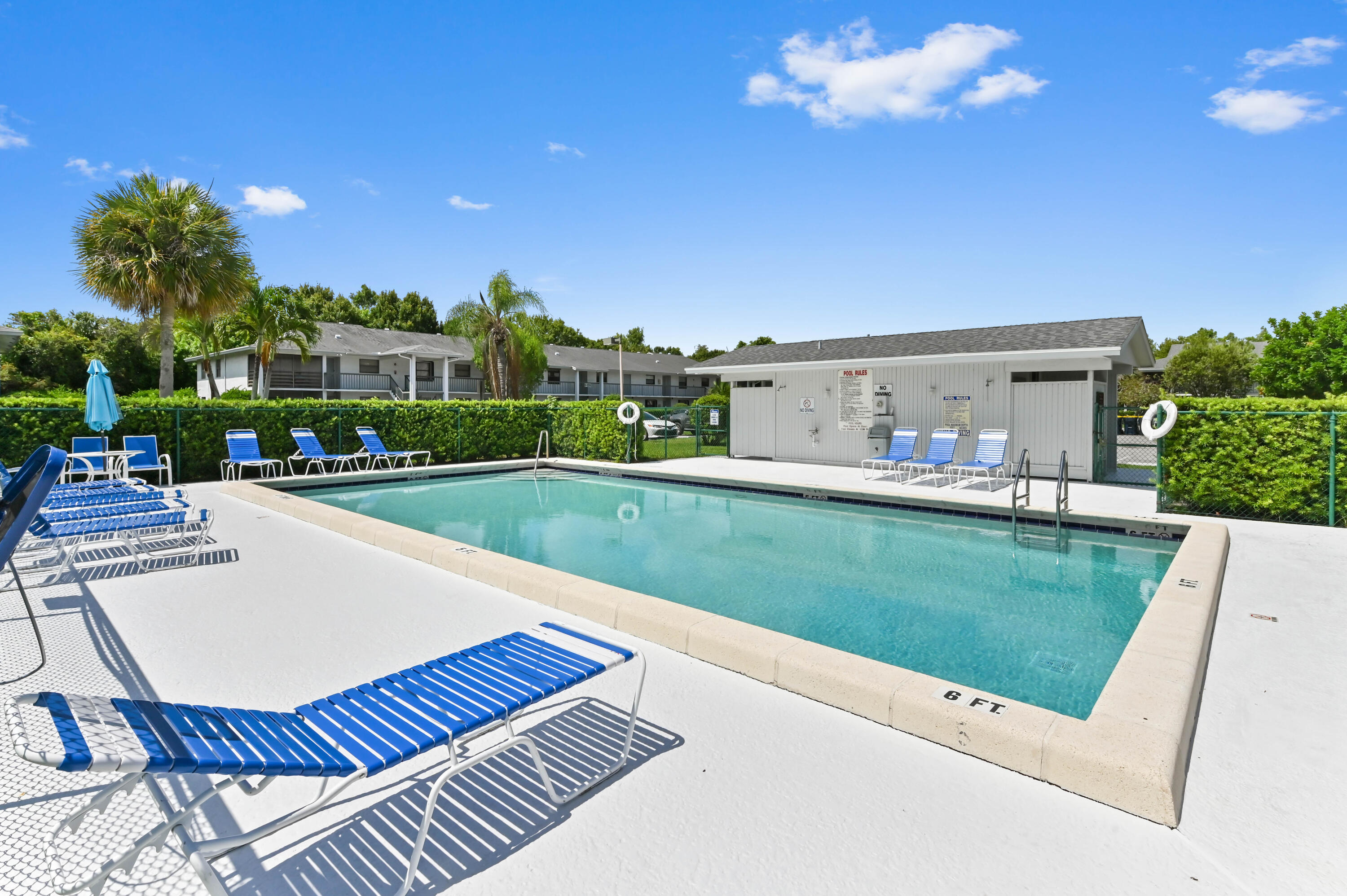 1230 Southeast Parkview Place, Unit D2 Stuart, FL 34994 - Photo 30 of 34 a view of a house with a swimming pool and a yard