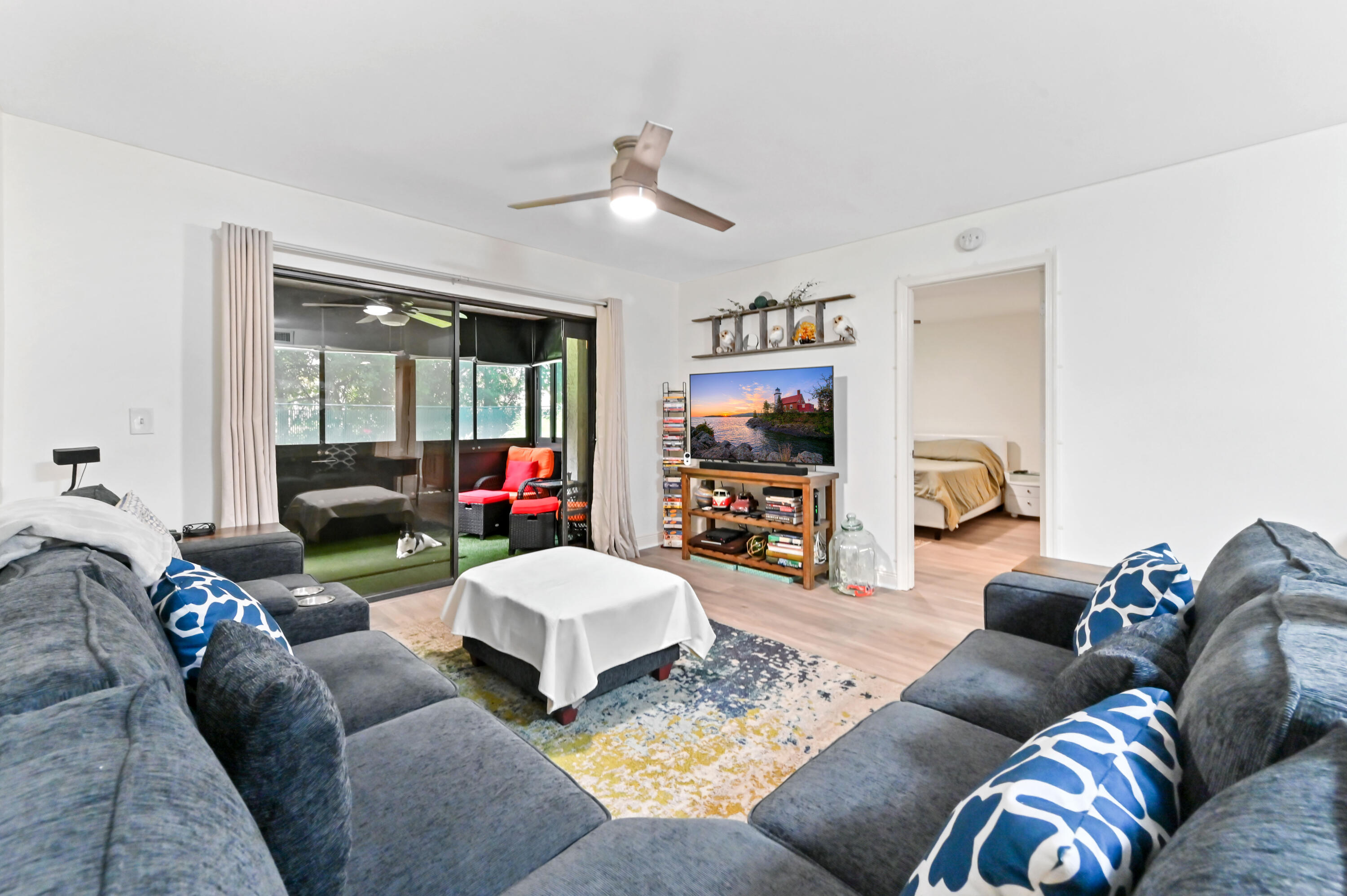 1230 Southeast Parkview Place, Unit D2 Stuart, FL 34994 - Photo 5 of 34 a living room with furniture and a flat screen tv