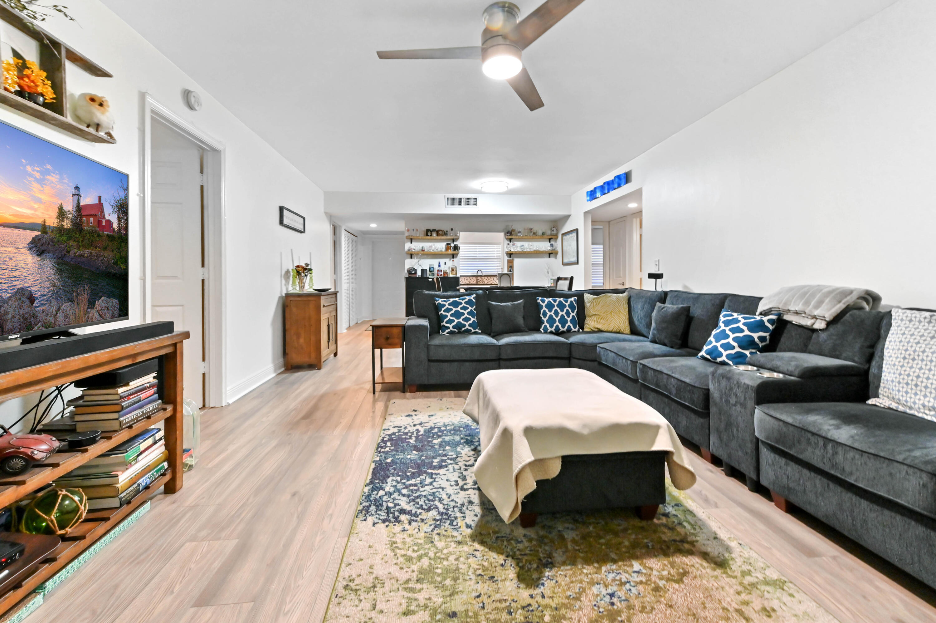 1230 Southeast Parkview Place, Unit D2 Stuart, FL 34994 - Photo 6 of 34 a living room with furniture and a flat screen tv