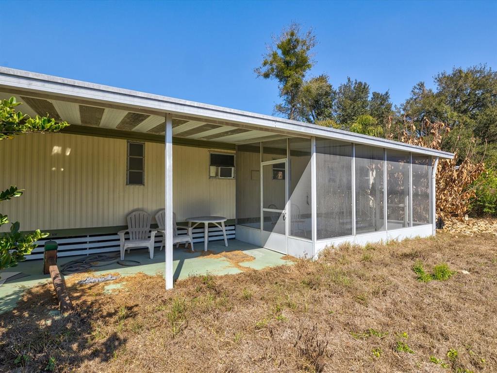 4512 Lane Road Zephyrhills, FL 33541 - Photo 1 of 14 front view of a house with a large window and potted plants