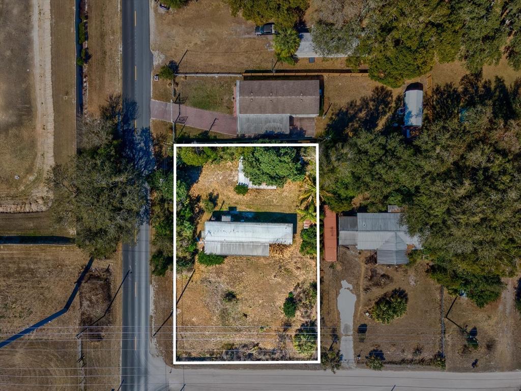4512 Lane Road Zephyrhills, FL 33541 - Photo 7 of 14 aerial view of a house with a yard