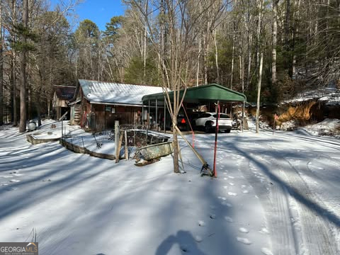2594 Blue Ridge Gap Road Clayton, GA 30525 - Photo 20 of 77 a view of a patio with a table and chairs under an umbrella