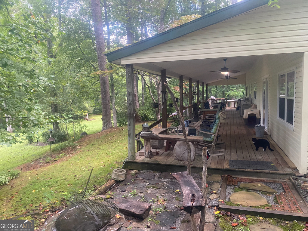 2594 Blue Ridge Gap Road Clayton, GA 30525 - Photo 7 of 77 a view of a patio with table and chairs potted plants with large tree