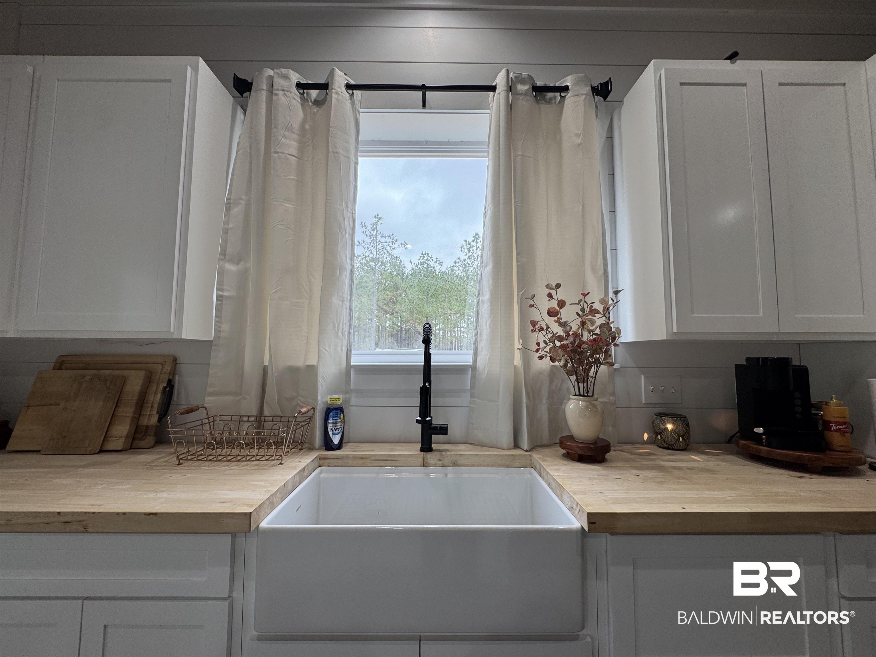 370 Dianne Road Frisco City, AL 36445 - Photo 14 of 41 Interior space with white cabinets, wooden counters, and sink