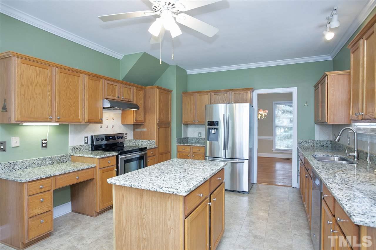 5216 Covington Bend Drive Raleigh, NC 27613 - Photo 5 of 15 Another view of the kitchen demonstrates how roomy it is, perfect for having helpers while you prepare a meal.
