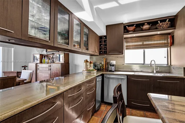 a kitchen with stainless steel appliances granite countertop a stove and a refrigerator