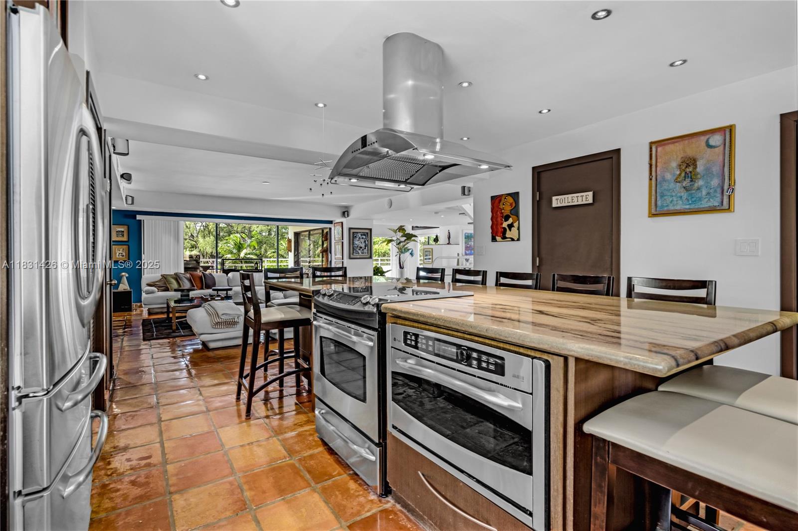 3520 Rockerman Road Miami, FL 33133 - Photo 18 of 41 a kitchen with stainless steel appliances granite countertop a stove and a refrigerator