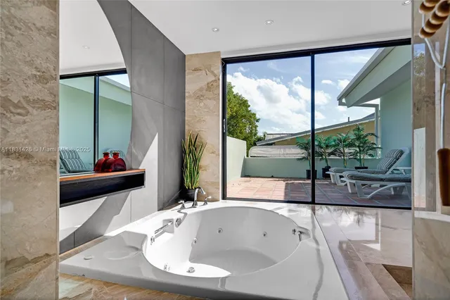 a view of a swimming pool with a patio and a yard