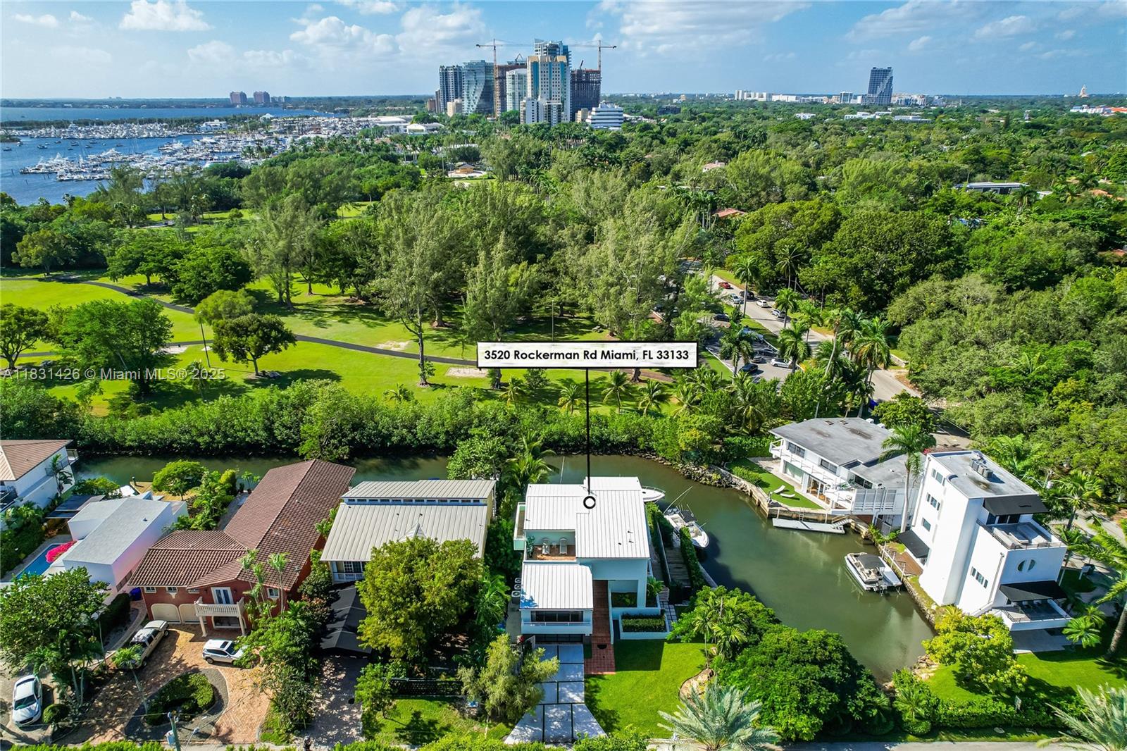 3520 Rockerman Road Miami, FL 33133 - Photo 39 of 41 an aerial view of a house with a yard and lake view