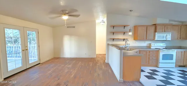 a view of a hallway with windows and wooden floor